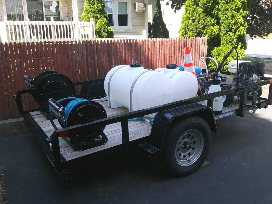 V.I.P Window Cleaning trailer with cleaning supply drums and sprayers